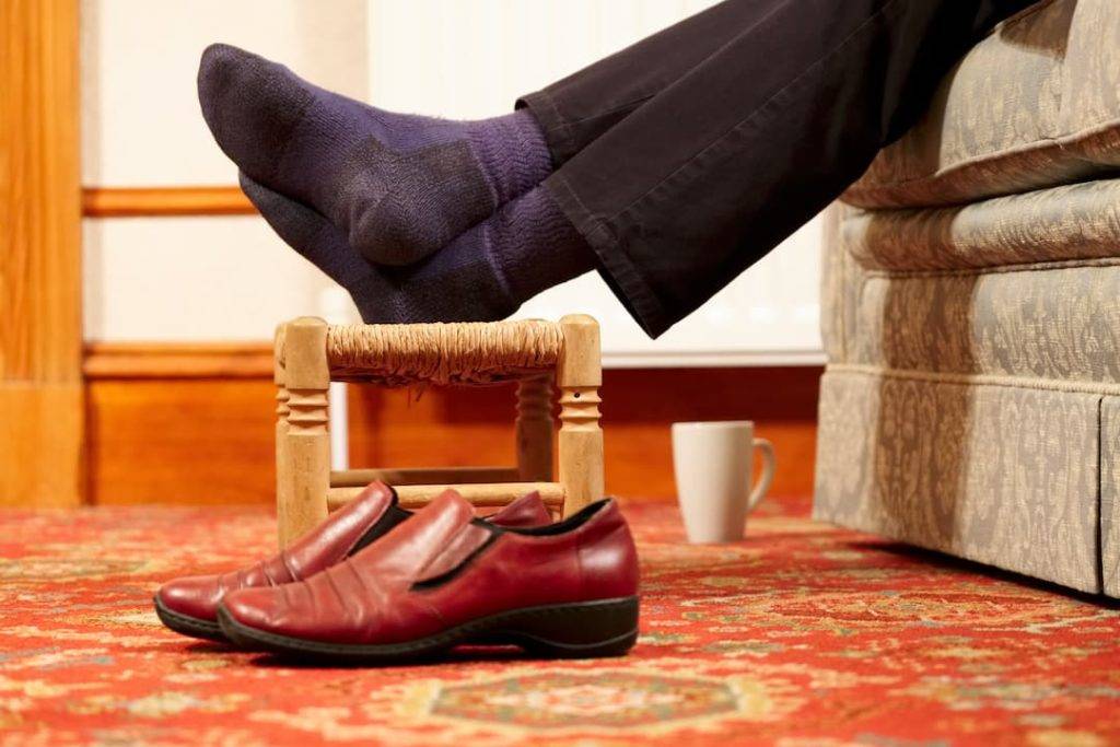 man with his feet up on a footstool